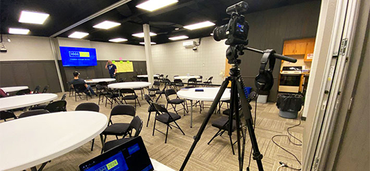 Production camera and laptop in an empty workshop room