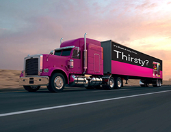 An image of a pink semi truck with a Quatro banner on the side